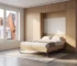Optimized small space in a Montreal apartment featuring a fully integrated, modern hidden wall bed within custom cabinetry.